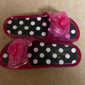 Kate Spade pink jelly slides with rose & black & white polka dot soles.